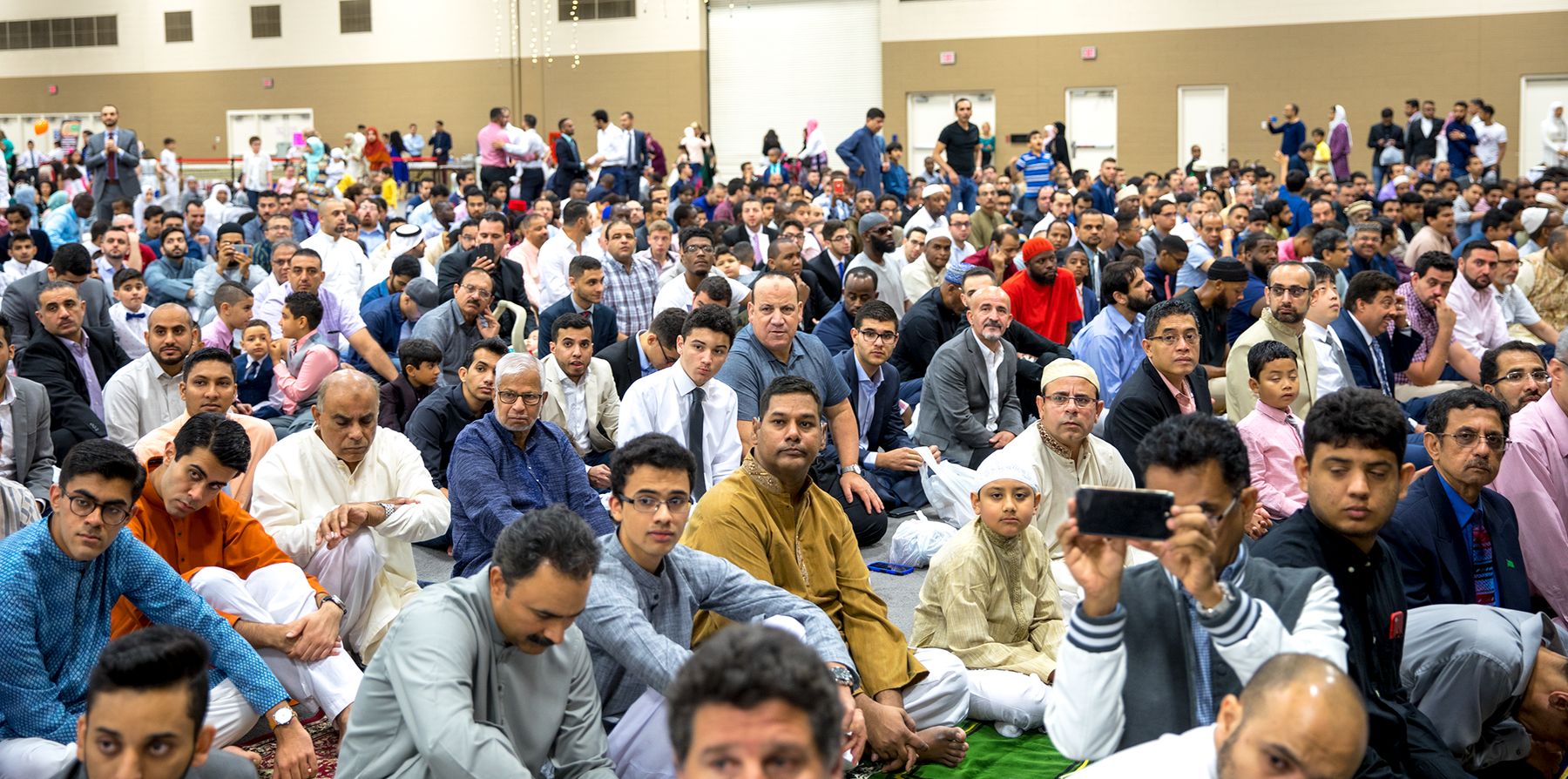Hundreds of men and boys from the Masjid Saad community seated together for Eid prayer